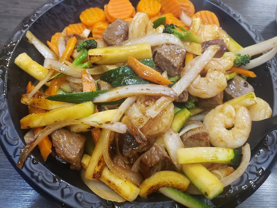 Printed menu with chicken and vegetable plates.